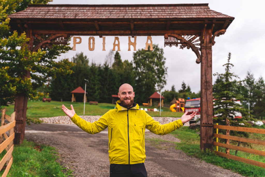 Me, posing in front of the wooden gate in Poiana Negri